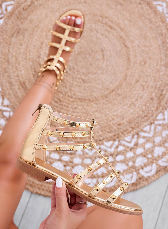 Gold flat sandals wrapped with studs