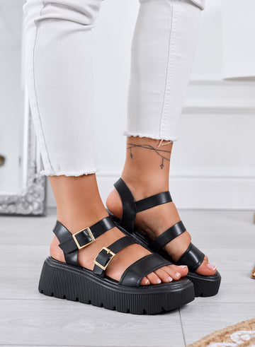 MORA - Sandalias negras chunky con doble hebilla dorada y suela tipo tren de aterrizaje