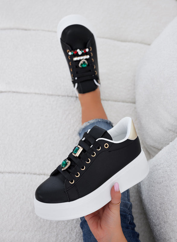 Black sneakers with green jewel embellishments