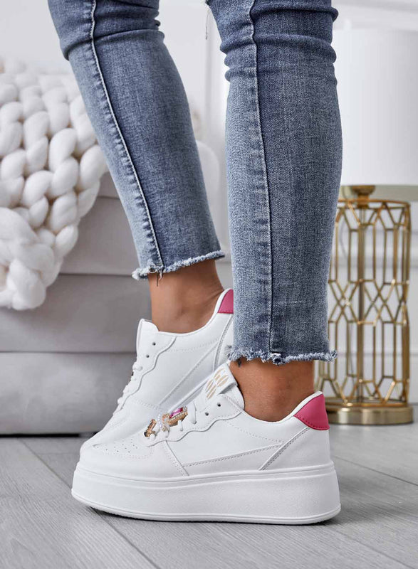 White sneakers with jeweled embellishments and fuchsia heel