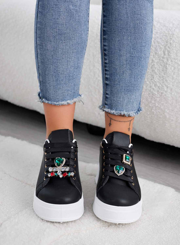 Black sneakers with green jewel embellishments