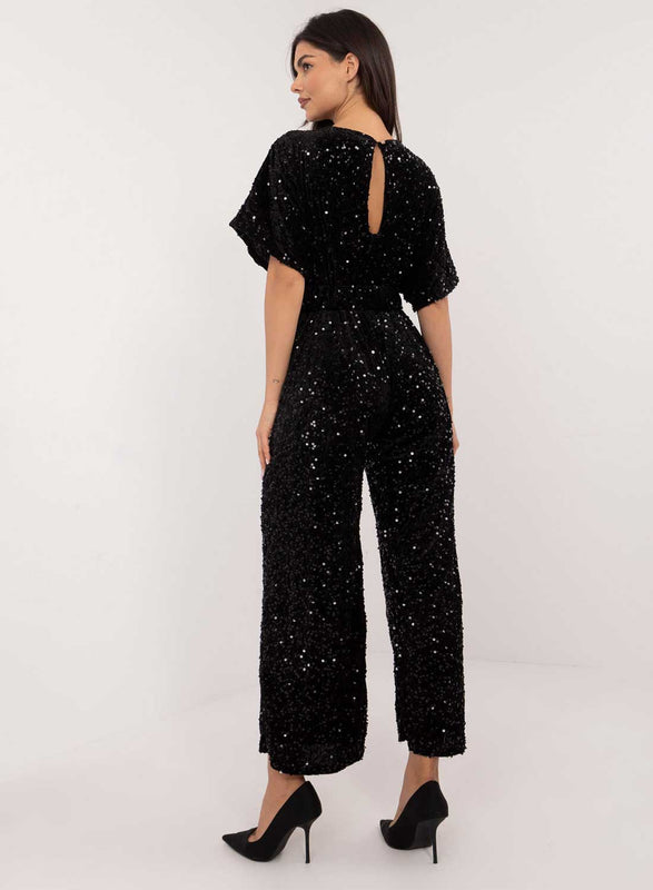 Tuta nera in paillettes con cintura in vita