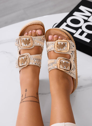 ENRICA - Sandalias beige tipo chancla con hebillas doradas y strass