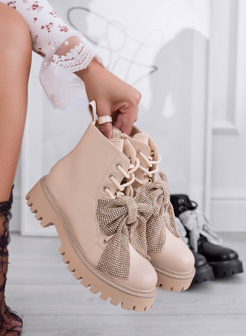 Beige combat boots with jeweled bow