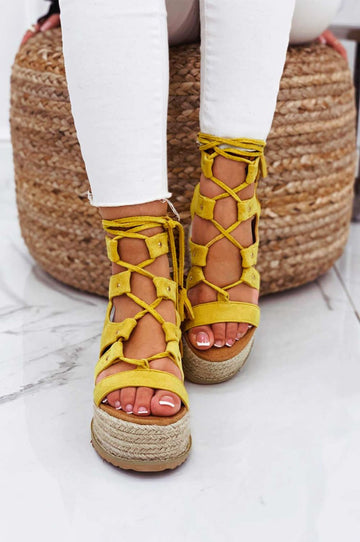 Yellow lace-up sandals with rope wedge