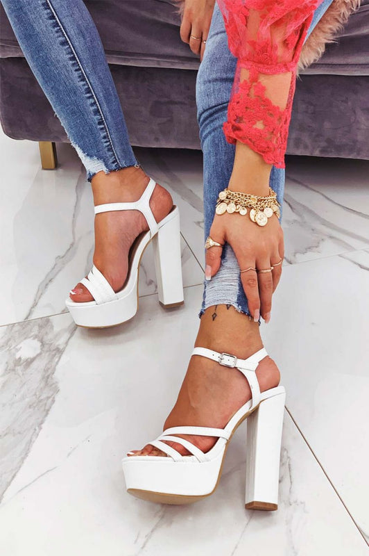 White high-heeled sandals in faux leather
