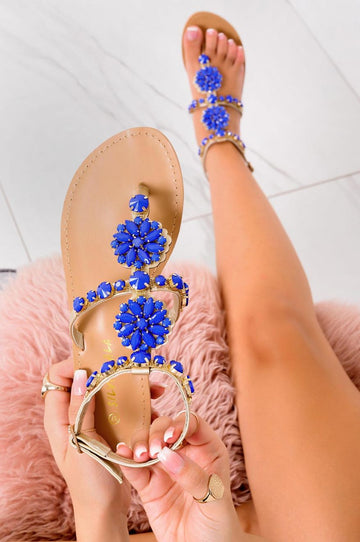 Sandalias joya planas doradas con piedras azules