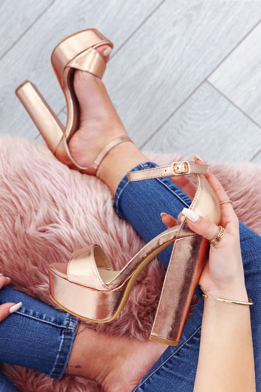 Metallic rose gold sandals with high heel and ankle strap