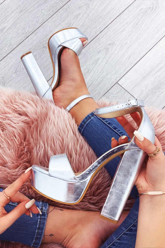 Metallic silver sandals with high heel and ankle strap