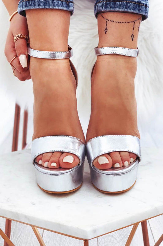 Metallic silver sandals with high heel and ankle strap