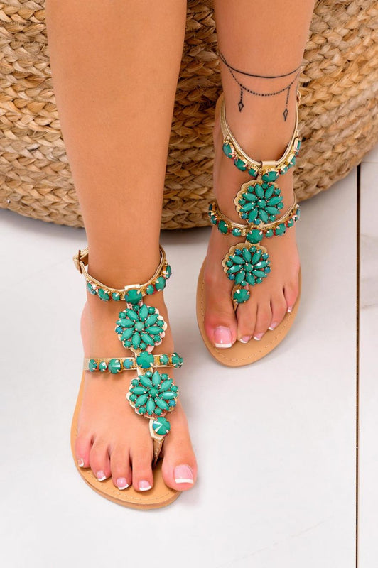 Sandalias joya planas doradas con piedras verdes