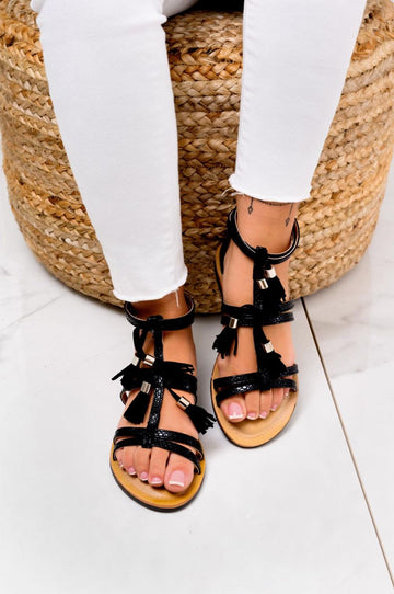 Black flat sandals with fringe charms