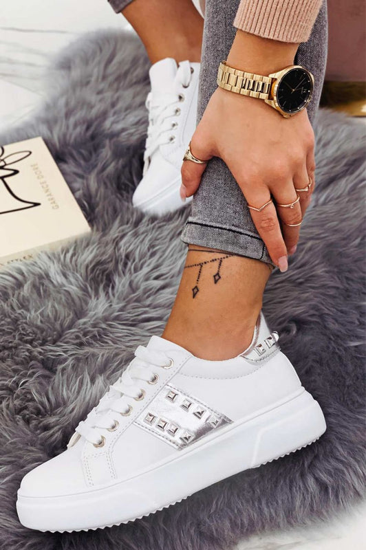 White sneakers with silver inserts and studs