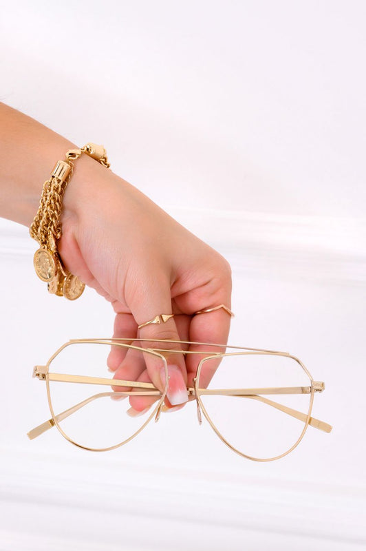 Occhiali con lenti trasparenti e montatura oro