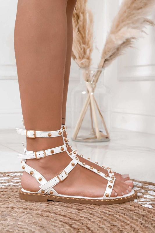 White flat sandals with gold sphere studs